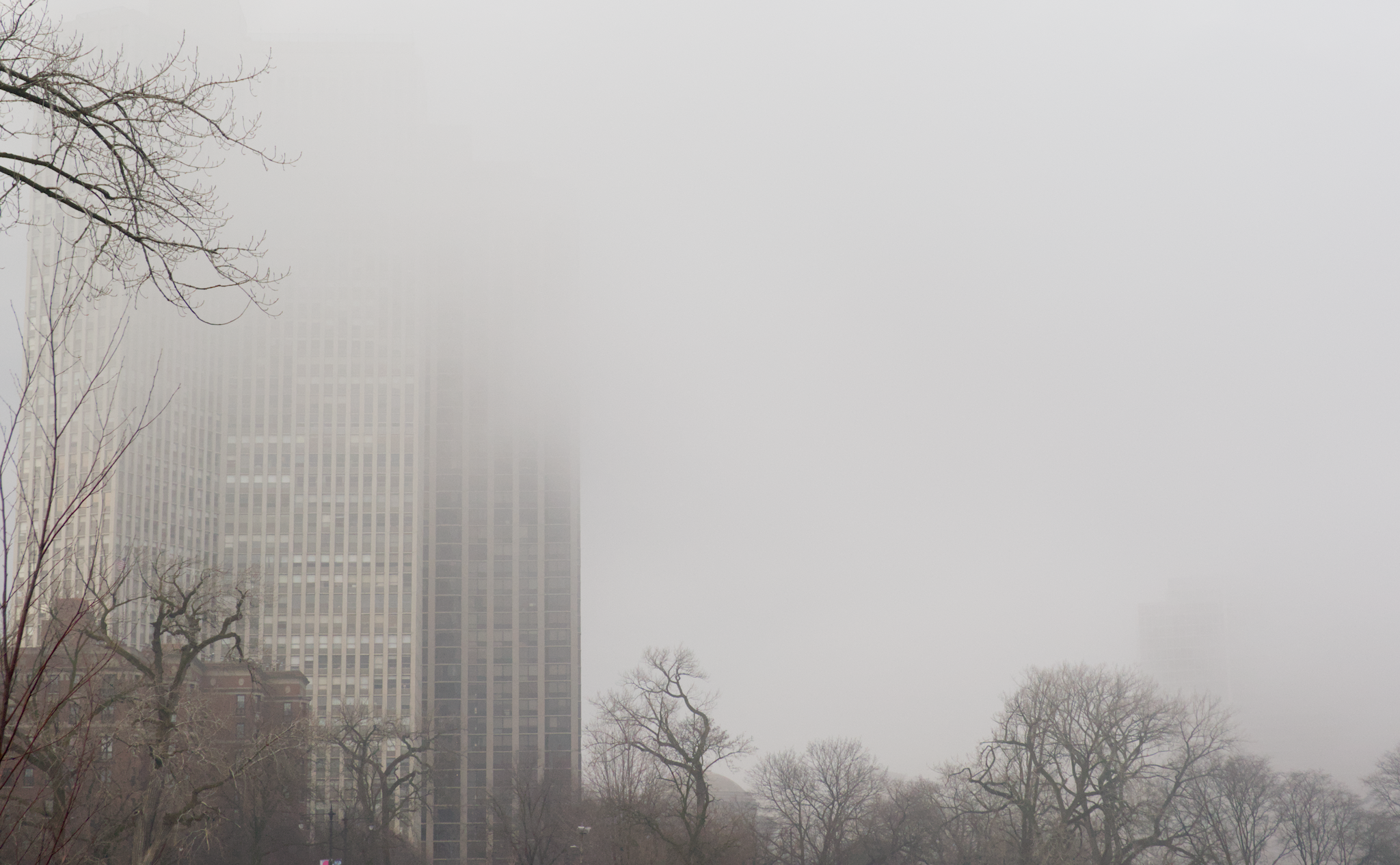 The Chicago skyline shrouded in fog, seen from a northern pier.