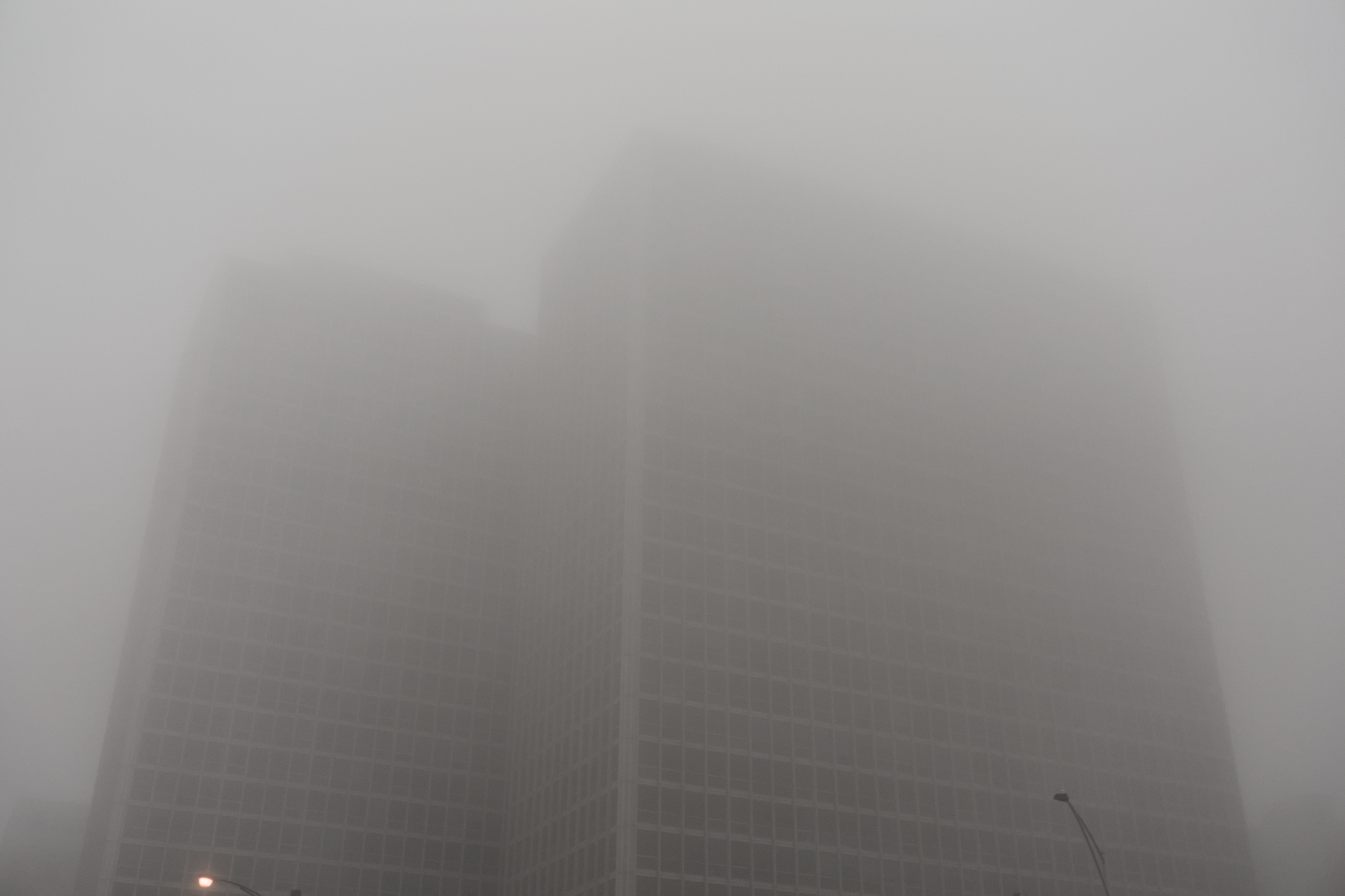 The Chicago skyline shrouded in fog, seen from a northern pier.