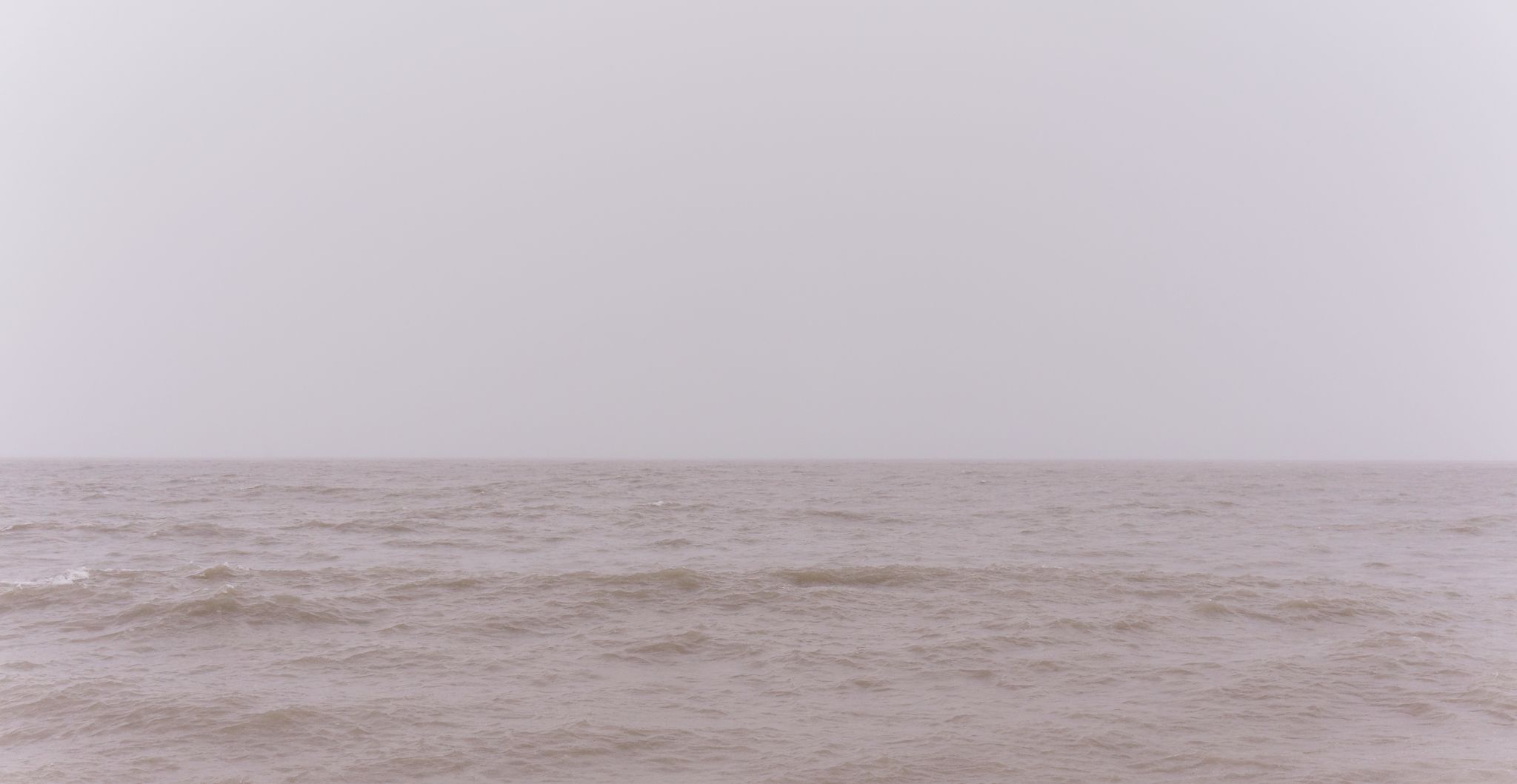 The Chicago skyline shrouded in fog, seen from a northern pier.